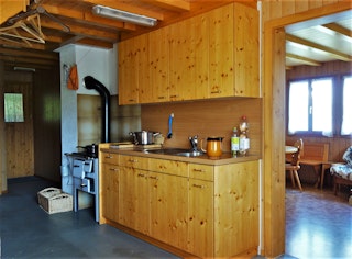 Praktisch eingerichtete Küche mit Holzkochherd 