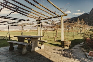 The stone table under the pergola is at your disposal