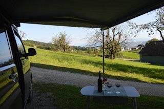 The farm's own welcome wine awaits with a great view of the vines, Lake Sempach and Pilatus